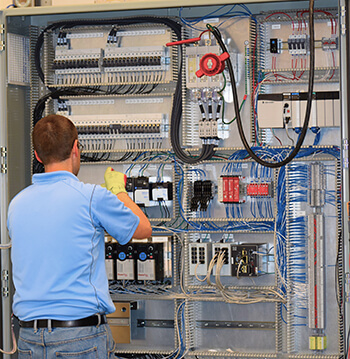 Shambaugh electrician work on a large custom electrical panel 