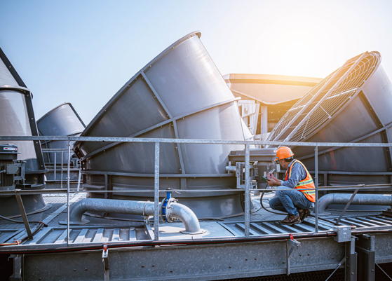 Man wearing safety gear on the rooftop of a food processing facility
